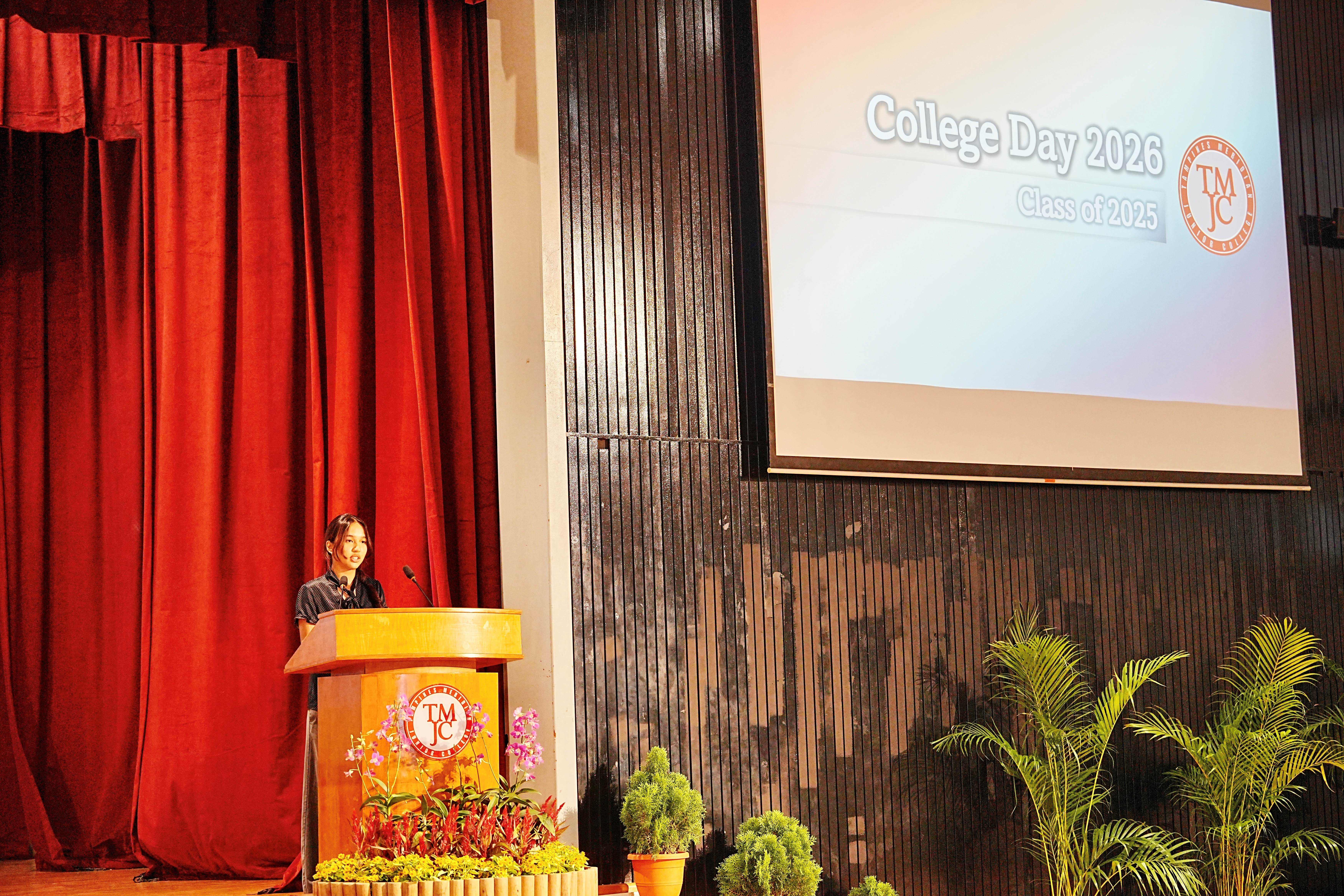A student delivering the valediction speech at the TMJC podium during College Day 2026 for the Class of 2025.
